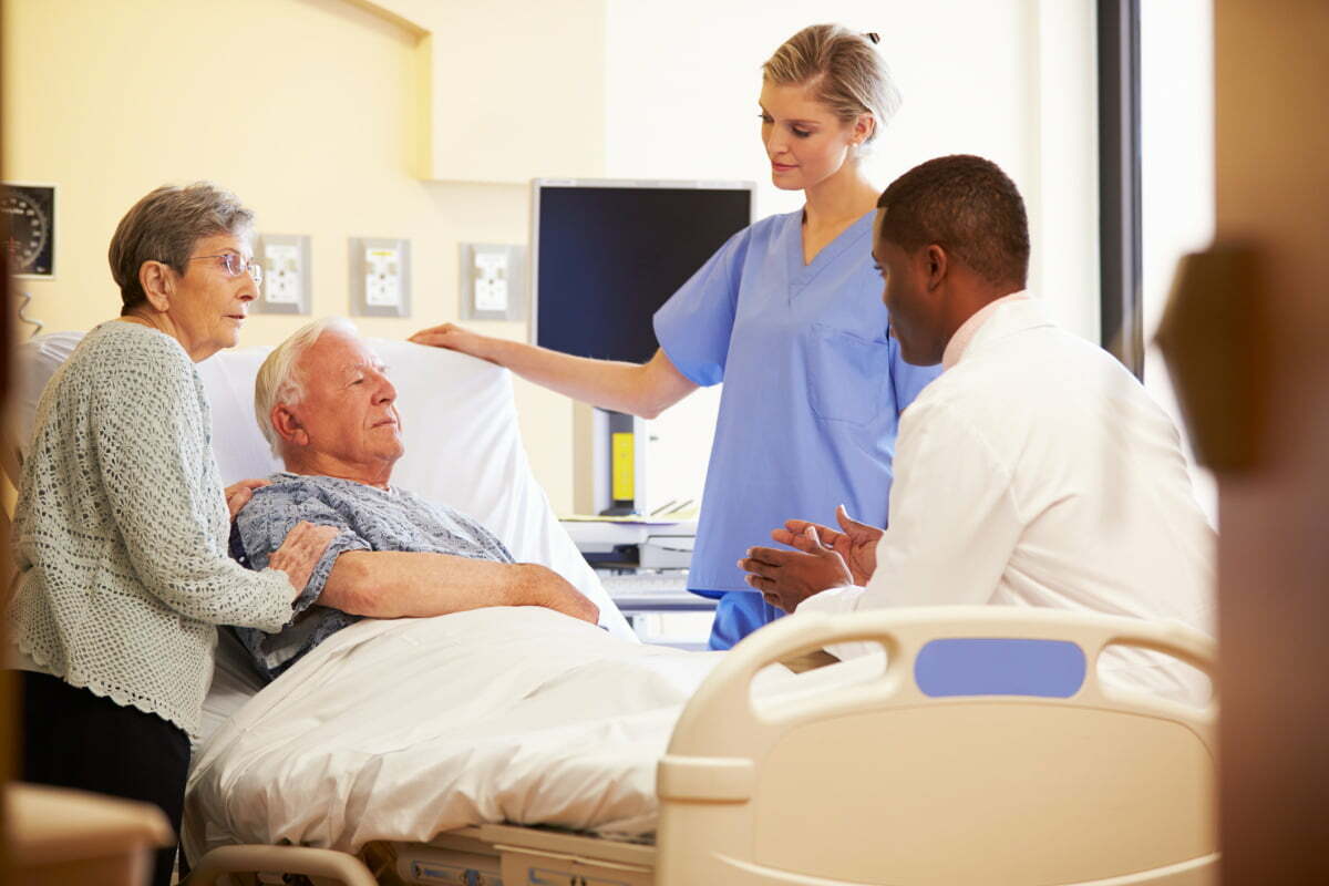 Elderly Husband and Wife Discussing Diagnosis with Medical Team