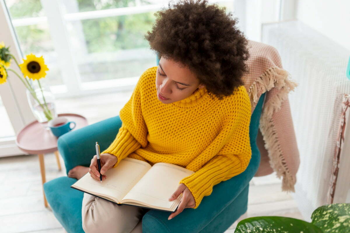 Woman Journaling in the Winter to Keep Mind and Spirit Positive and Healthy