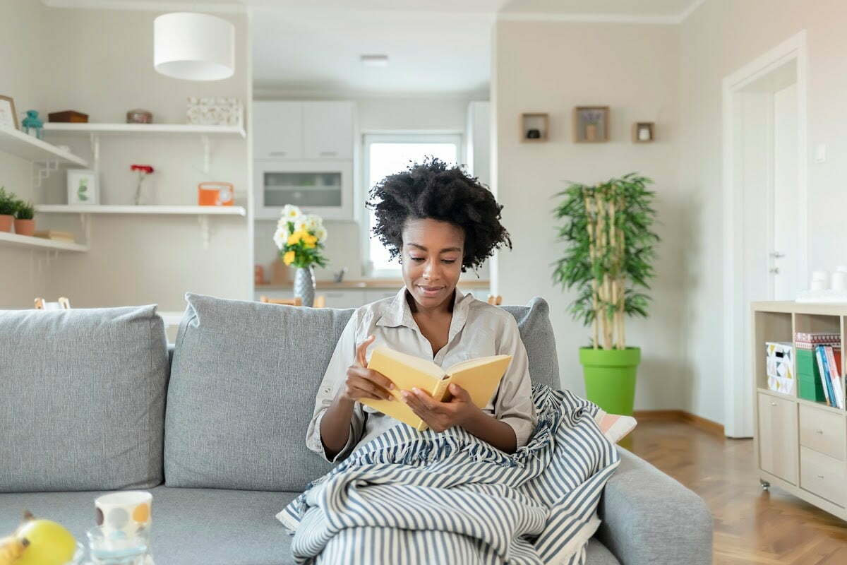 Woman Reading a Book in Her Living Room