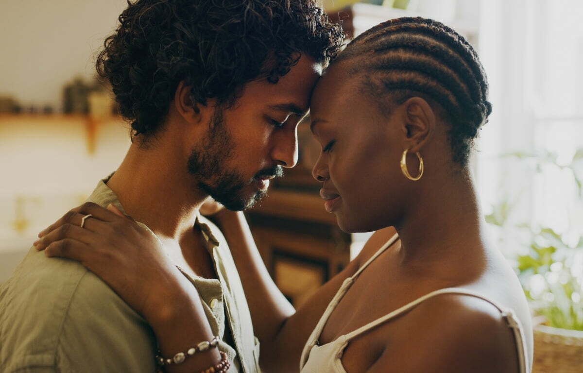 A man and woman hugging while experiencing secondhand grief