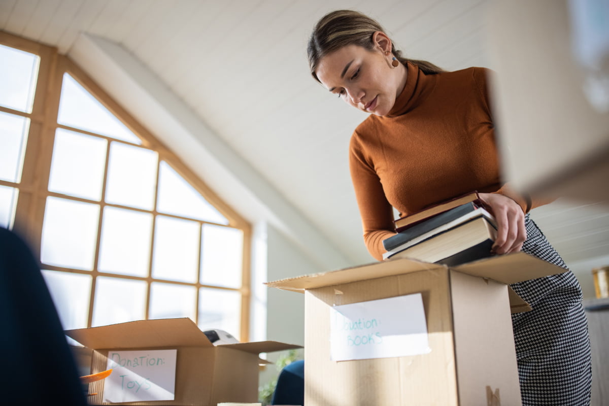 Woman going through boxes of things after family member passed away